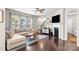 Comfortable living room features a fireplace, TV, hardwood floors, and natural light at 15211 Colonial Park Dr, Huntersville, NC 28078