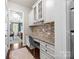 Charming office nook features custom cabinetry, granite countertops, and natural light at 15211 Colonial Park Dr, Huntersville, NC 28078