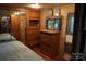 The RV main bedroom includes built-in storage and a comfortable bed with mirrors at 155 Holly Harbor Trl, Mount Gilead, NC 27306