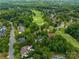 Picturesque aerial view of community with a golf course, lush greenery, and beautiful homes at 18800 Boundary Oaks Ct, Davidson, NC 28036