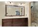 Bathroom with double sinks, a granite countertop, and a glass walk-in shower at 18800 Boundary Oaks Ct, Davidson, NC 28036