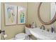 Charming half bathroom features a framed mirror, updated fixtures, and neutral tones at 18800 Boundary Oaks Ct, Davidson, NC 28036