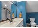 Well-lit bathroom with a modern sink, stylish mirror, and white toilet at 18800 Boundary Oaks Ct, Davidson, NC 28036