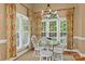 Dining room with large windows, natural light, patterned curtains, and a round wooden table at 18800 Boundary Oaks Ct, Davidson, NC 28036