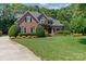 Lovely brick home boasting a lush green lawn and mature landscaping at 18800 Boundary Oaks Ct, Davidson, NC 28036