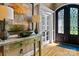 Welcoming foyer showcasing hardwood floors, stylish console table, and decorative lighting at 18800 Boundary Oaks Ct, Davidson, NC 28036