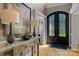 Grand foyer with decorative doors, hardwood floors, and elegant decor at 18800 Boundary Oaks Ct, Davidson, NC 28036