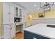 An eat-in kitchen features a glass display cabinet, stainless appliances, and hardwood floors at 18800 Boundary Oaks Ct, Davidson, NC 28036