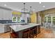 Bright eat-in kitchen featuring a large kitchen island, stainless appliances, and natural light at 18800 Boundary Oaks Ct, Davidson, NC 28036