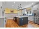 Bright eat-in kitchen with a large kitchen island, stainless appliances, and hardwood floors at 18800 Boundary Oaks Ct, Davidson, NC 28036