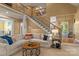 Open living room with a fireplace, staircase, and a view into the dining area at 18800 Boundary Oaks Ct, Davidson, NC 28036