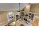 Great view of the living room's fireplace, built-in shelves, and access to sunroom and dining area at 18800 Boundary Oaks Ct, Davidson, NC 28036
