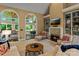 Bright living room features a fireplace, built-in shelves, and access to sunroom at 18800 Boundary Oaks Ct, Davidson, NC 28036