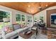 Cozy sunroom with lots of windows, wood ceilings, and tile floors at 18800 Boundary Oaks Ct, Davidson, NC 28036