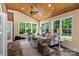 Beautiful sunroom filled with lots of windows for natural light and wood ceilings at 18800 Boundary Oaks Ct, Davidson, NC 28036