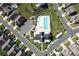 Aerial view showcasing the community pool, clubhouse, playground, and surrounding neighborhood in a well-planned layout at 2097 Saddlebred Dr, Iron Station, NC 28080