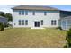 The back of a two-story home featuring a spacious backyard with grass and an outdoor shed at 2097 Saddlebred Dr, Iron Station, NC 28080