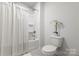 Clean bathroom with a shower-tub combination and modern toilet for a simple and functional design at 2097 Saddlebred Dr, Iron Station, NC 28080