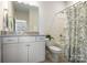 Bright bathroom with a granite countertop, garden tub and a shower featuring a green leafy shower curtain at 2097 Saddlebred Dr, Iron Station, NC 28080