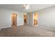 Carpeted bedroom with ensuite bath and walk-in closet providing ample storage space and comfort at 2097 Saddlebred Dr, Iron Station, NC 28080