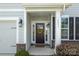 Close-up of a charming front door with sidelights, decorative wreath, and address number at 2097 Saddlebred Dr, Iron Station, NC 28080