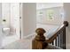 Upstairs hallway and staircase with wood railing, leading to bedrooms and bathroom at 2097 Saddlebred Dr, Iron Station, NC 28080