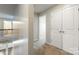 Upstairs hallway featuring carpeted flooring and closet doors, with views of the staircase and living space at 2097 Saddlebred Dr, Iron Station, NC 28080
