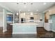 Gourmet kitchen with stainless steel appliances, quartz countertops and an eat in island with pendant lighting at 2097 Saddlebred Dr, Iron Station, NC 28080