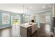 Spacious kitchen with an island overlooking the dining room, living room and sliding door to the backyard at 2097 Saddlebred Dr, Iron Station, NC 28080