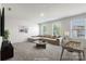 Staged living room offers cozy seating, natural light, and a foosball table for entertainment at 2097 Saddlebred Dr, Iron Station, NC 28080