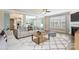 Bright living room features a ceiling fan, fireplace, and large windows with lots of natural light at 2097 Saddlebred Dr, Iron Station, NC 28080