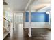 Open-concept living area with hardwood floors, a stairway and decorative columns, creating an airy feel at 2097 Saddlebred Dr, Iron Station, NC 28080