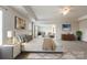 Bright main bedroom boasting a tray ceiling, large windows, and neutral décor, creating a relaxing atmosphere at 2097 Saddlebred Dr, Iron Station, NC 28080