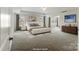 Spacious main bedroom with tray ceiling, carpet, and large windows providing ample natural light at 2097 Saddlebred Dr, Iron Station, NC 28080