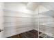 Walk-in pantry features rows of wire shelving for optimal storage in this dream home at 2097 Saddlebred Dr, Iron Station, NC 28080
