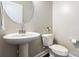 Classic powder room features a pedestal sink and white toilet at 2097 Saddlebred Dr, Iron Station, NC 28080