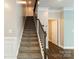 Inviting staircase featuring carpeted steps and stylish railing, leading to the upper level of this home at 2097 Saddlebred Dr, Iron Station, NC 28080