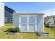 Well-maintained storage shed with double doors, perfect for organizing and storing outdoor equipment and gardening supplies at 2097 Saddlebred Dr, Iron Station, NC 28080