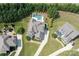 An aerial view showcases this home's beautiful lot, landscaping, and inground pool at 221 N Centurion Ln, Mount Holly, NC 28120