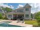 Backyard of home with swimming pool, and porch with seating at 221 N Centurion Ln, Mount Holly, NC 28120