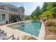Backyard pool with tanning deck, and a covered porch perfect for entertaining at 221 N Centurion Ln, Mount Holly, NC 28120