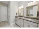 Bathroom with granite countertops, dual sinks, white cabinets, and tile flooring at 221 N Centurion Ln, Mount Holly, NC 28120