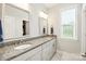 Bright bathroom featuring double sinks, granite counters, and large mirrors at 221 N Centurion Ln, Mount Holly, NC 28120
