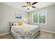 Inviting bedroom with a queen-sized bed, floral bedding, and a window offering natural light at 221 N Centurion Ln, Mount Holly, NC 28120