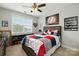 Spacious bedroom with sports decor, a baseball-themed quilt, and a window with natural light at 221 N Centurion Ln, Mount Holly, NC 28120