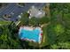 Aerial close up view of community pool with lounge chairs and umbrellas, offering a refreshing leisure experience at 221 N Centurion Ln, Mount Holly, NC 28120