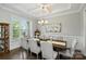 Elegant dining room with coffered ceilings, stylish lighting, and ample natural light at 221 N Centurion Ln, Mount Holly, NC 28120