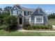 Charming two-story home with stone accents, manicured lawn, and inviting curb appeal at 221 N Centurion Ln, Mount Holly, NC 28120