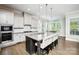 Modern kitchen with granite countertops, stainless steel appliances, and center island seating at 221 N Centurion Ln, Mount Holly, NC 28120
