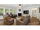 Spacious living room with fireplace, hardwood floors, and ample seating, perfect for gatherings at 221 N Centurion Ln, Mount Holly, NC 28120
